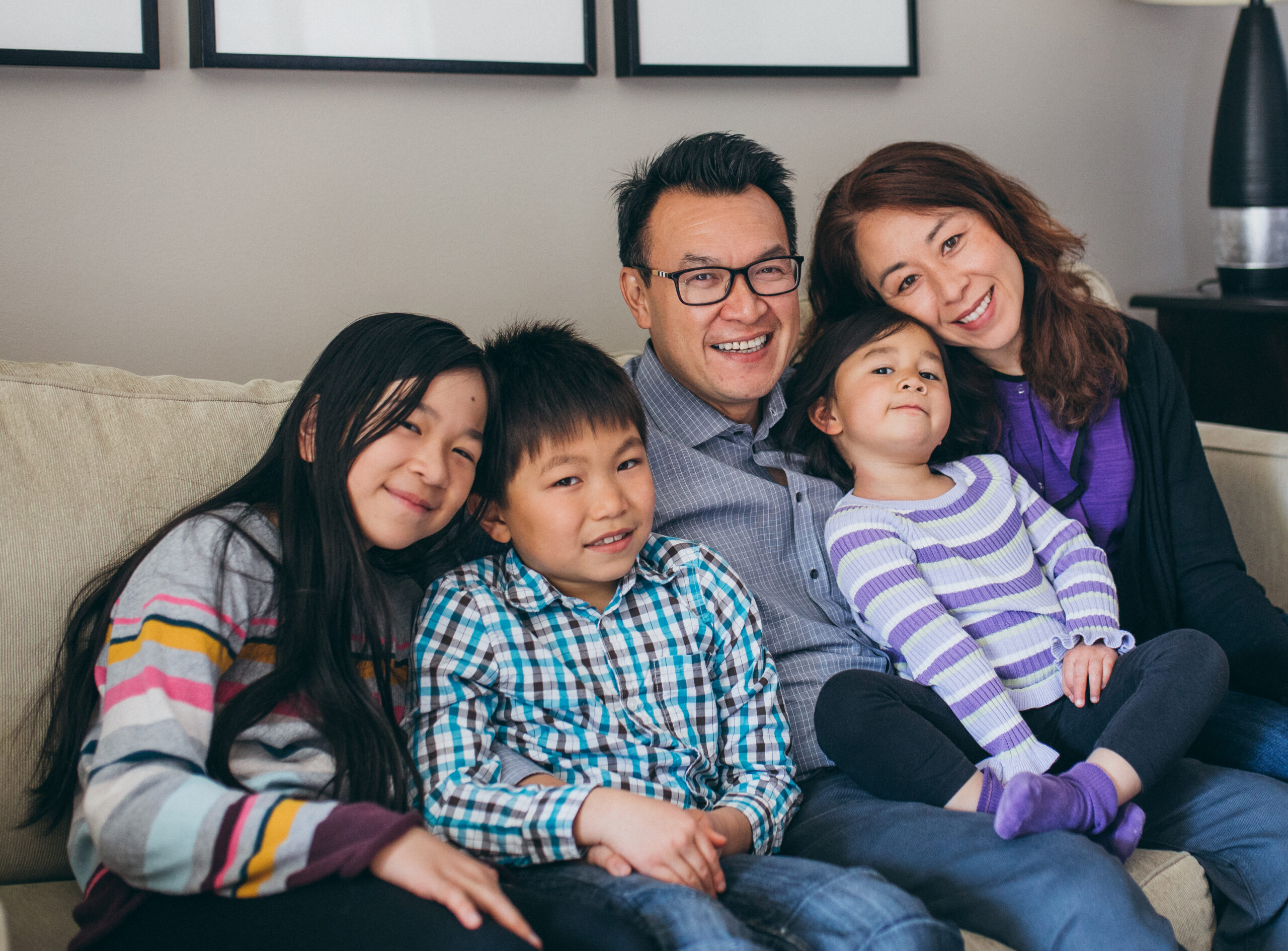 Dad and his family posing at home on a couch